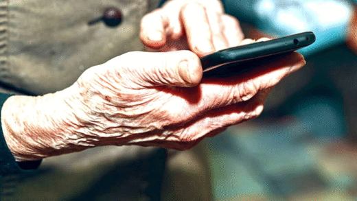 Elderly person using smartphone with concern