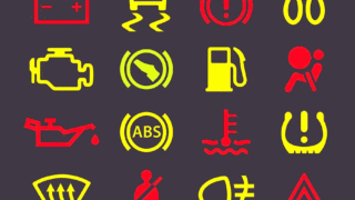 Image of brake warning lights on a car dashboard