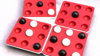 Pentago game with marbles and twisting board