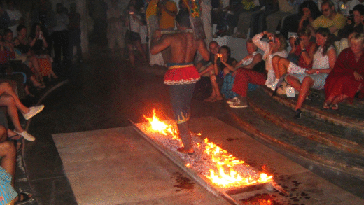 Participants walking on hot coals during a firewalking event