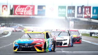 NASCAR car racing on wet track